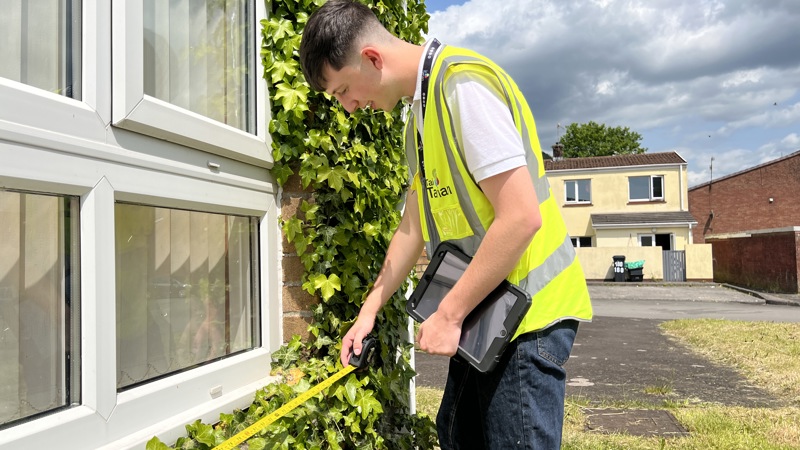 Surveyor measuring a window