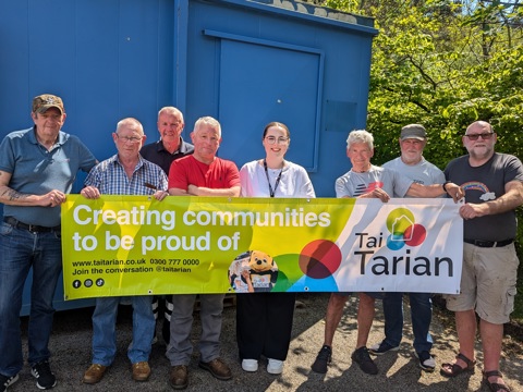 Tai Tarian staff and Men's Shed attendees holding a Tai Tarian banner