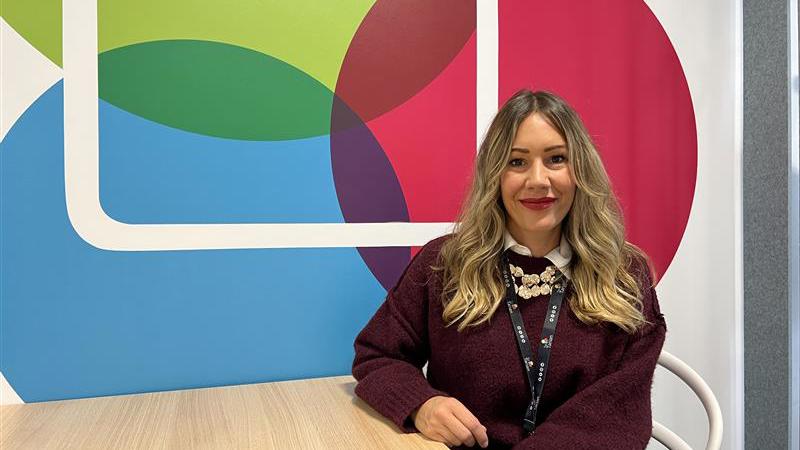 Ana sitting by a table