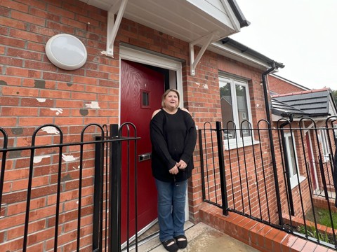 Tenant standing in front of a Clos Castan front door