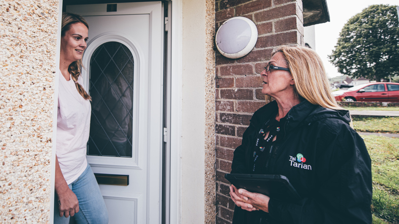 Tai Tarian staff member and tenant having a chat in a doorway