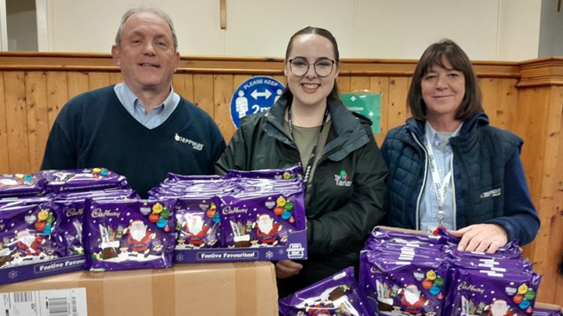 Tai Tarian and contractor staff with a donation of selection boxes