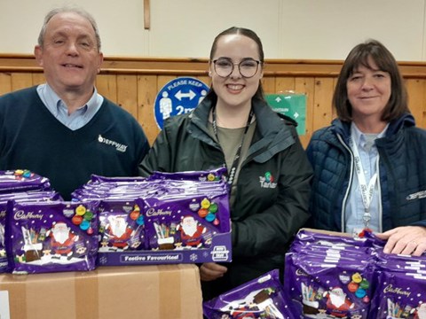 Tai Tarian and contractor staff with a donation of selection boxes