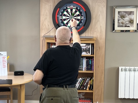 Haven resident throwing at a dart board