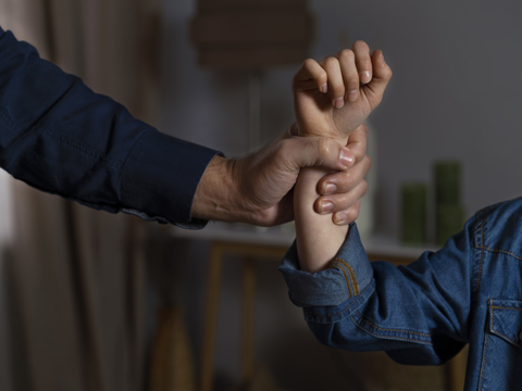 A person violently grabbing another person's wrist