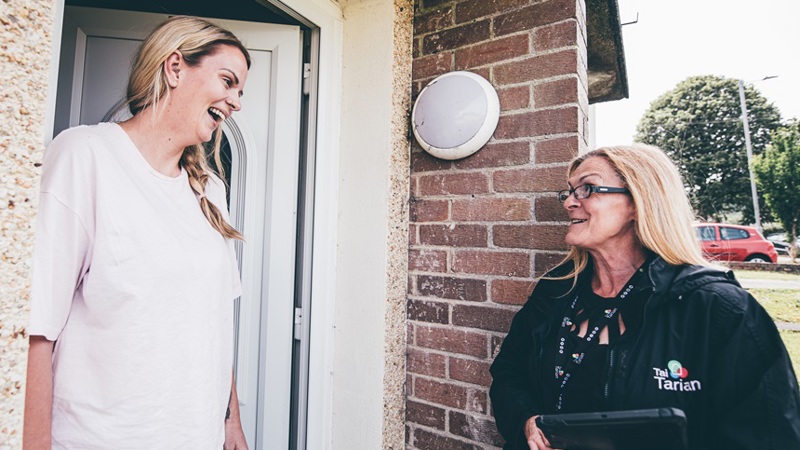 Tai Tarian Housing Officer with tenant at doorstep